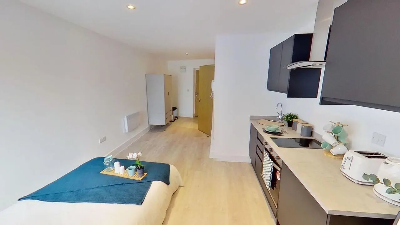 Bed kitchen wardrobe and hallway studio apartment at Dojo House Nottingham in Nottingham Student Accommodation
