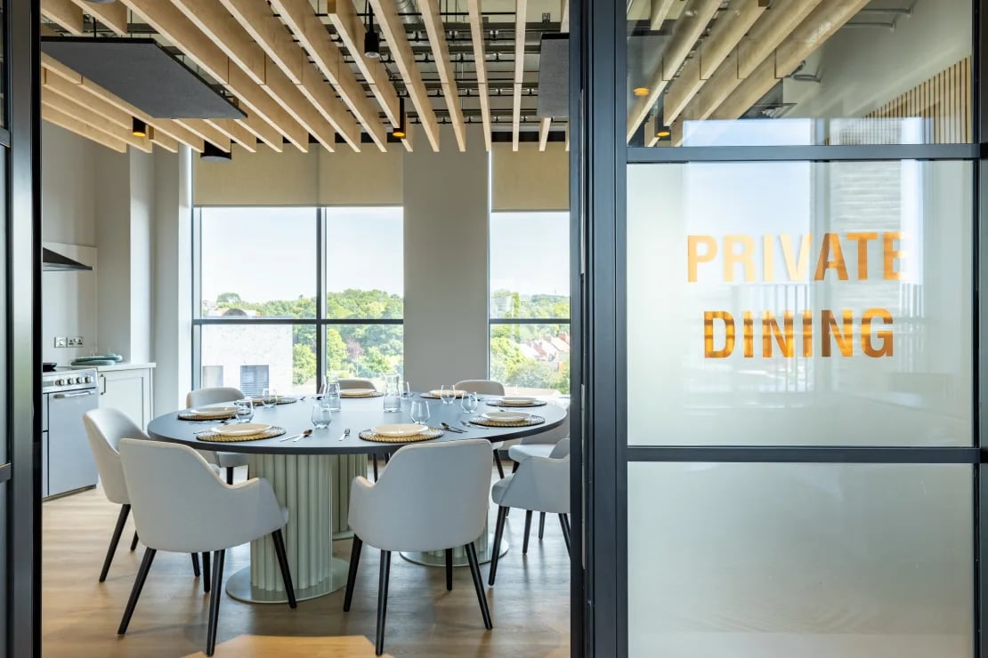 Dining table chairs and kitchen area dining area at Winfield Court in Nottingham Student Accommodation