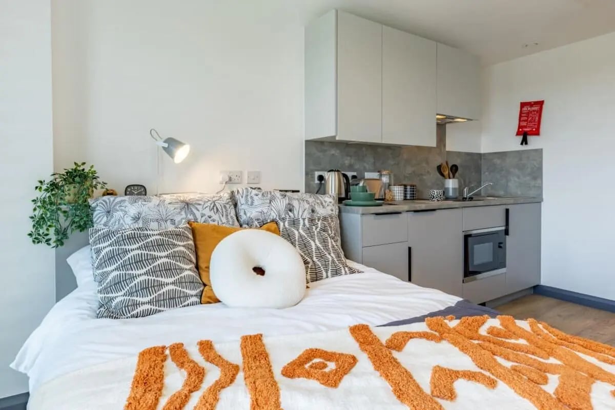 Bed with pillows kitchenette and microwave bedroom at Winfield Court in Nottingham Student Accommodation