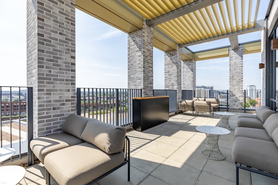 Outdoor lounge area with sofas and tables exterior at Winfield Court in Nottingham Student Accommodation