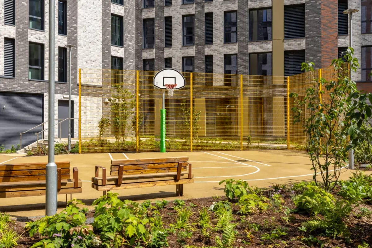Basketball court with benches and foliage exterior at Winfield Court in Nottingham Student Accommodation