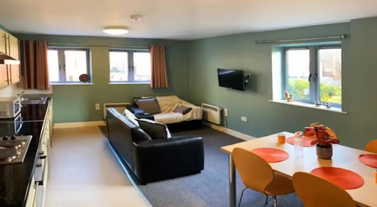 Kitchen sofas television dining table living room at Barker House in Newcastle Upon Tyne Student Accommodation