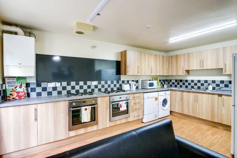 Kitchen with ovens washing machine and cabinets kitchen at Parham Student Village in Canterbury Student Accommodation