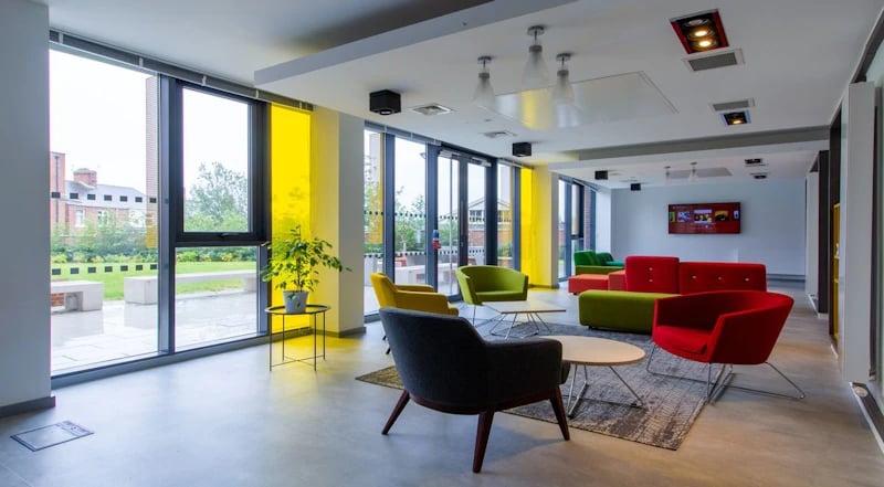 Colorful couches chairs tables plant living room at Duresme Court in Durham Student Accommodation