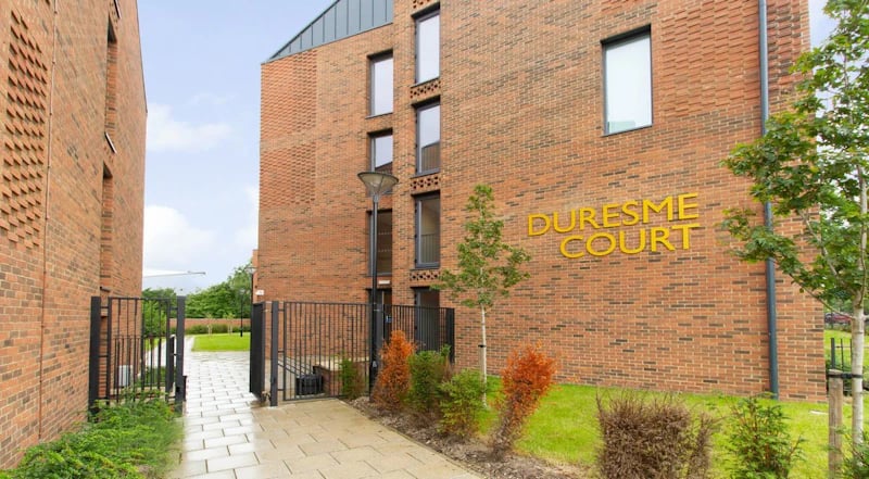 Duresme Court building exterior with gate and path Exterior at Duresme Court in Durham Student Accommodation