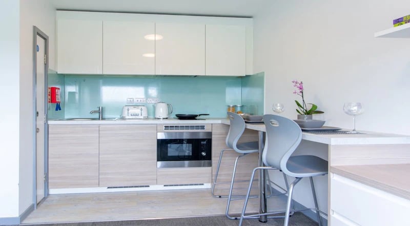 Modern student kitchen with appliances and seating kitchen at Duresme Court in Durham Student Accommodation
