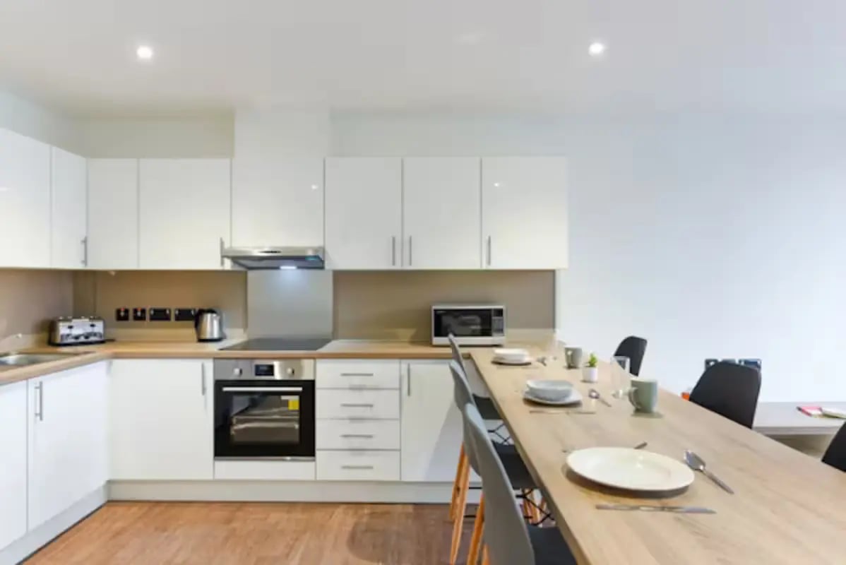 Modern white kitchen with dining table kitchen at Great Patrick Street in Belfast Student Accommodation
