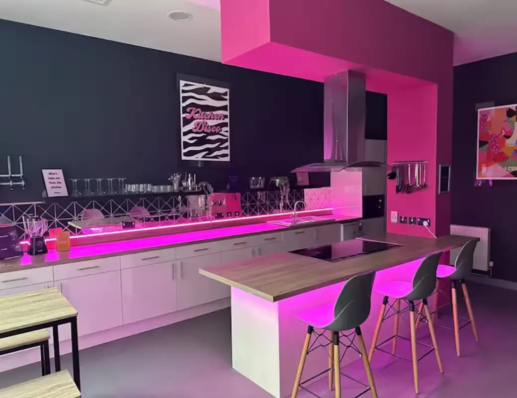 Modern kitchen with pink lighting and bar stools kitchen at Great Patrick Street in Belfast Student Accommodation