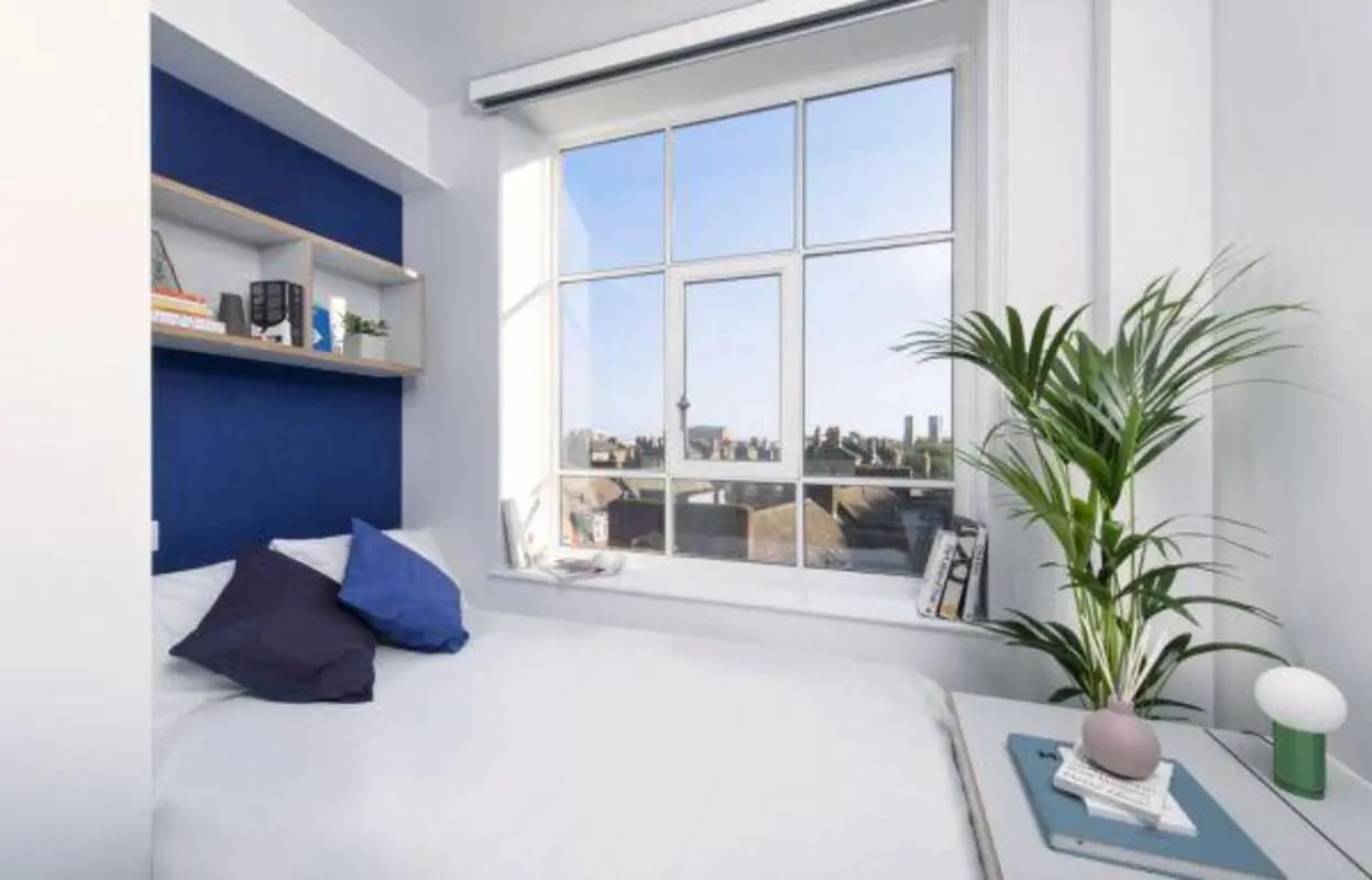 Bed with pillows and shelf bedroom exterior at Scape Bloomsbury in London Student Accommodation