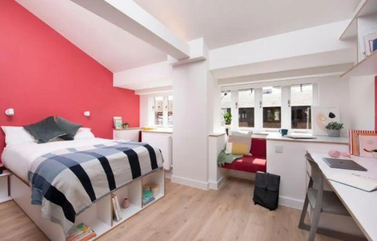 Bed desk bench and laptop bedroom study area at Scape Bloomsbury in London Student Accommodation
