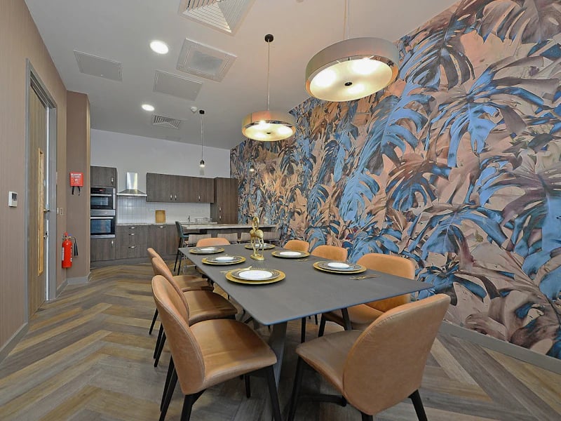 Dining table with chairs and kitchen area Communal area at Fontenoy Apartments in Liverpool Student Accommodation