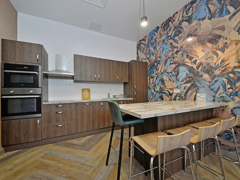 Modern kitchen with ovens cabinets island and stools kitchen at Fontenoy Apartments in Liverpool Student Accommodation