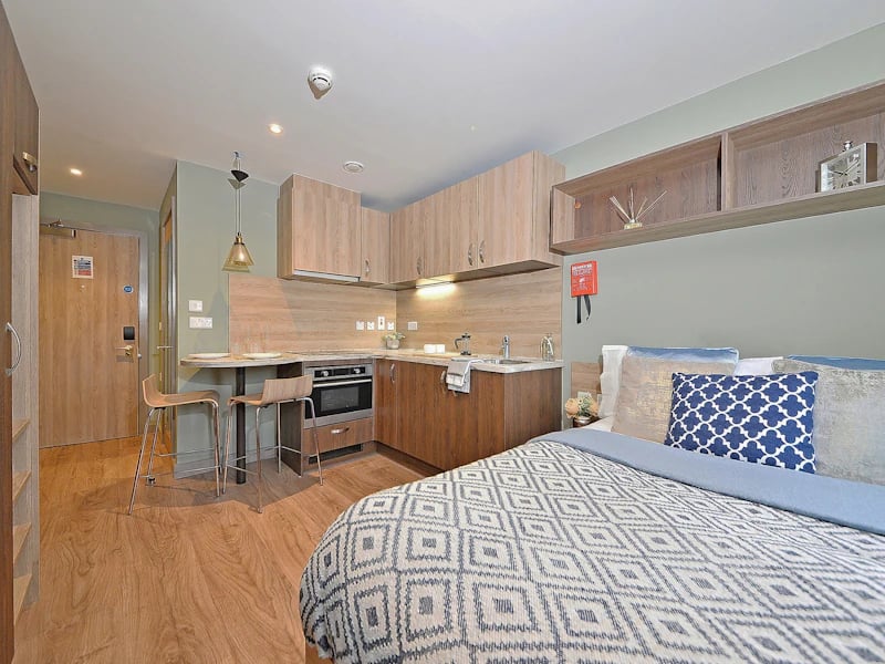 Bed kitchen area with stools and oven studio room at Fontenoy Apartments in Liverpool Student Accommodation