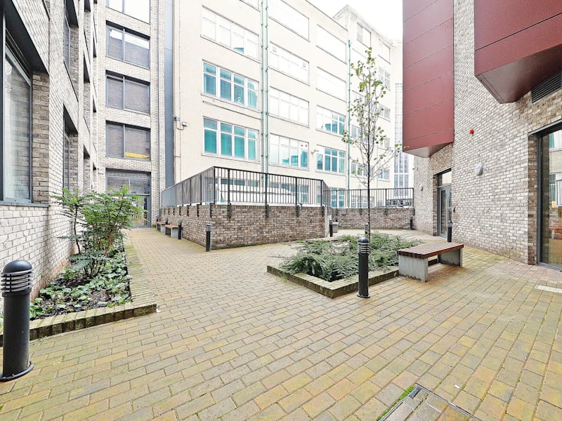 Courtyard with brick paving benches and plants exterior at Fontenoy Apartments in Liverpool Student Accommodation