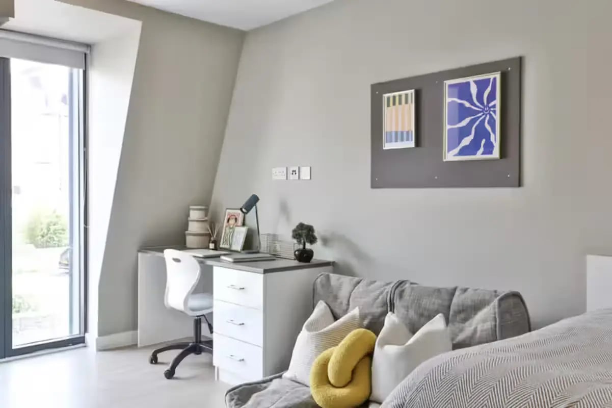 Desk with chair and sofa Bedroom at James House in Bath Student Accommodation
