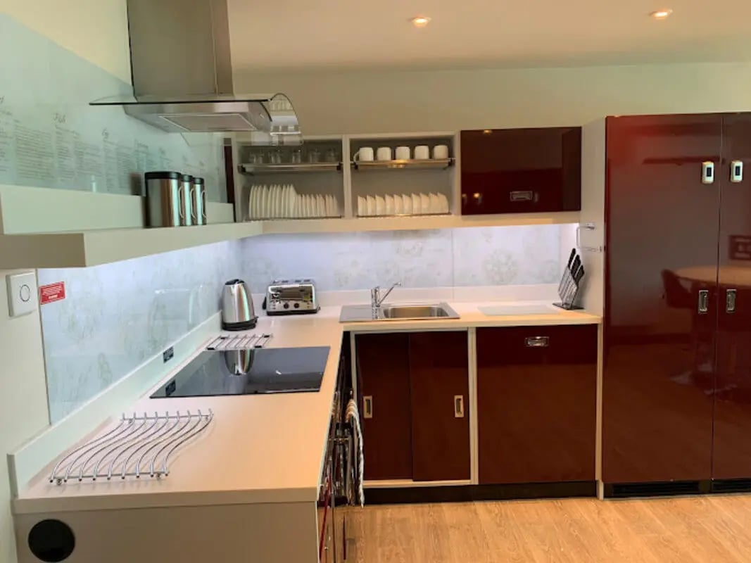 Modern kitchen with cabinets toaster kettle and fridge kitchen at Brotherton House in Leeds Student Accommodation