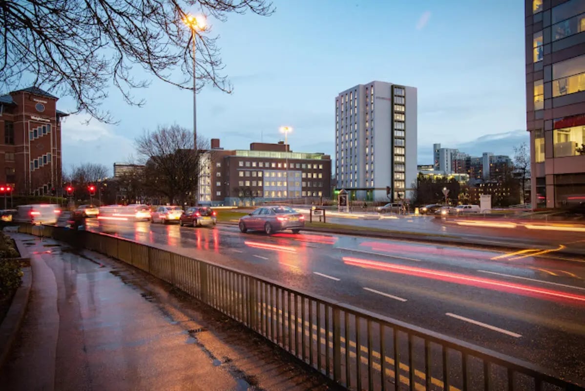 Modern accommodation buildings cars on wet road exterior at Brotherton House in Leeds Student Accommodation