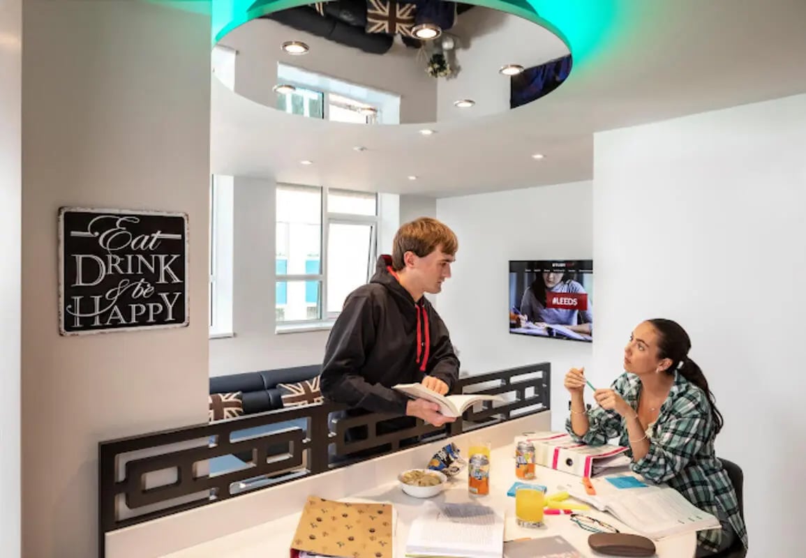 Students at table with snacks and books study area at Brotherton House in Leeds Student Accommodation