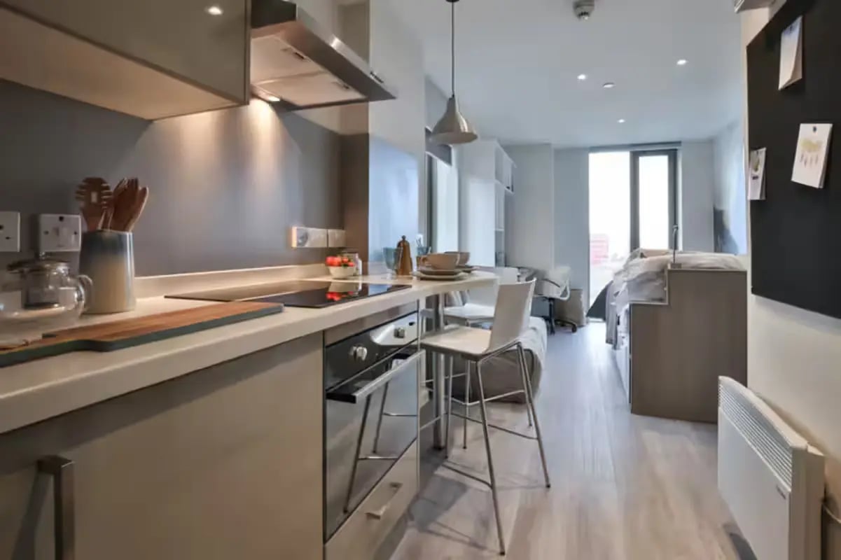 Modern kitchen with dining bar and bed area studio at The Emporium Birmingham in Birmingham Student Accommodation