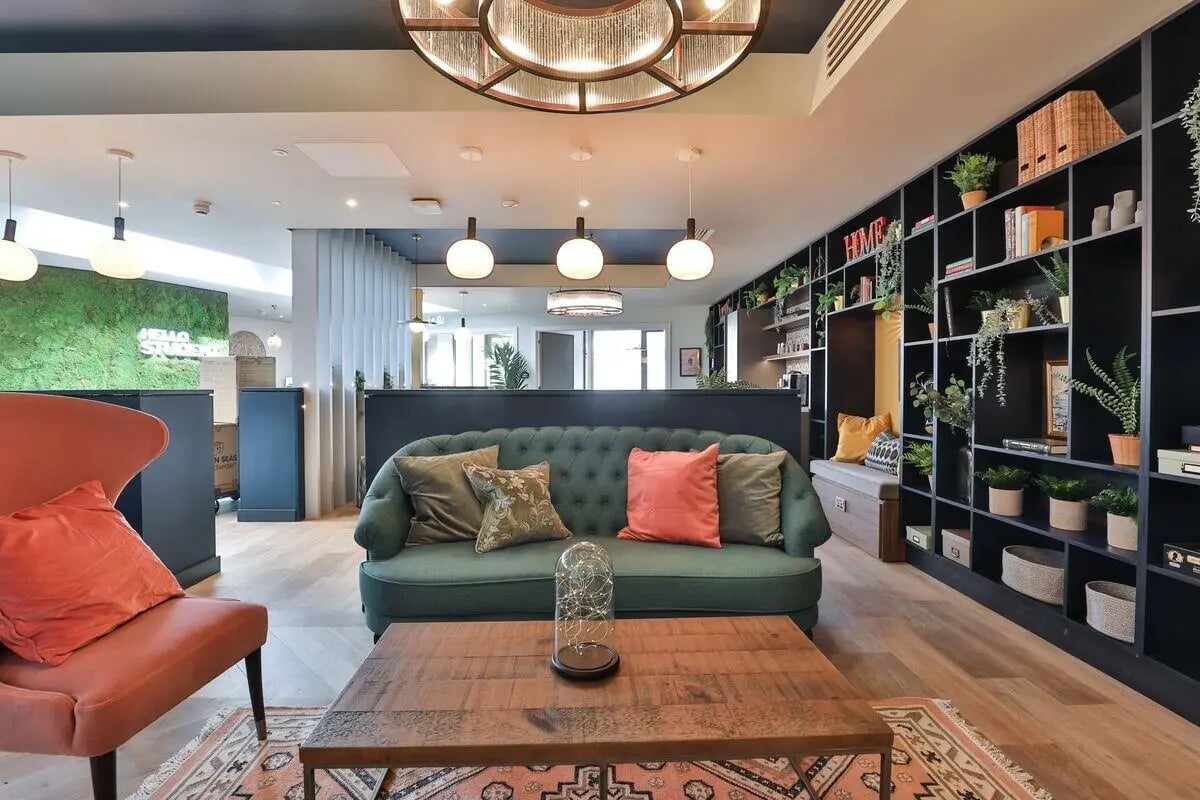 Green sofa with pillows and coffee table living room at St Mary's in Bristol Student Accommodation