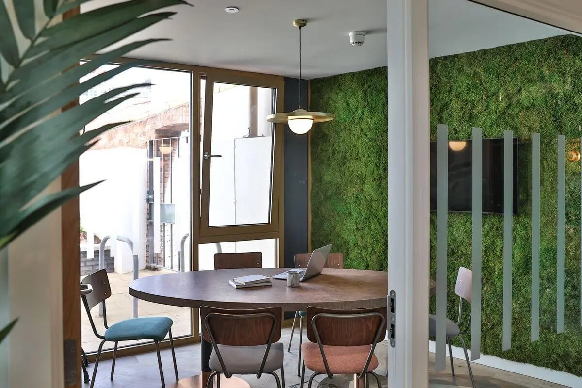 Round table chairs laptop moss wall study area at St Mary's in Bristol Student Accommodation