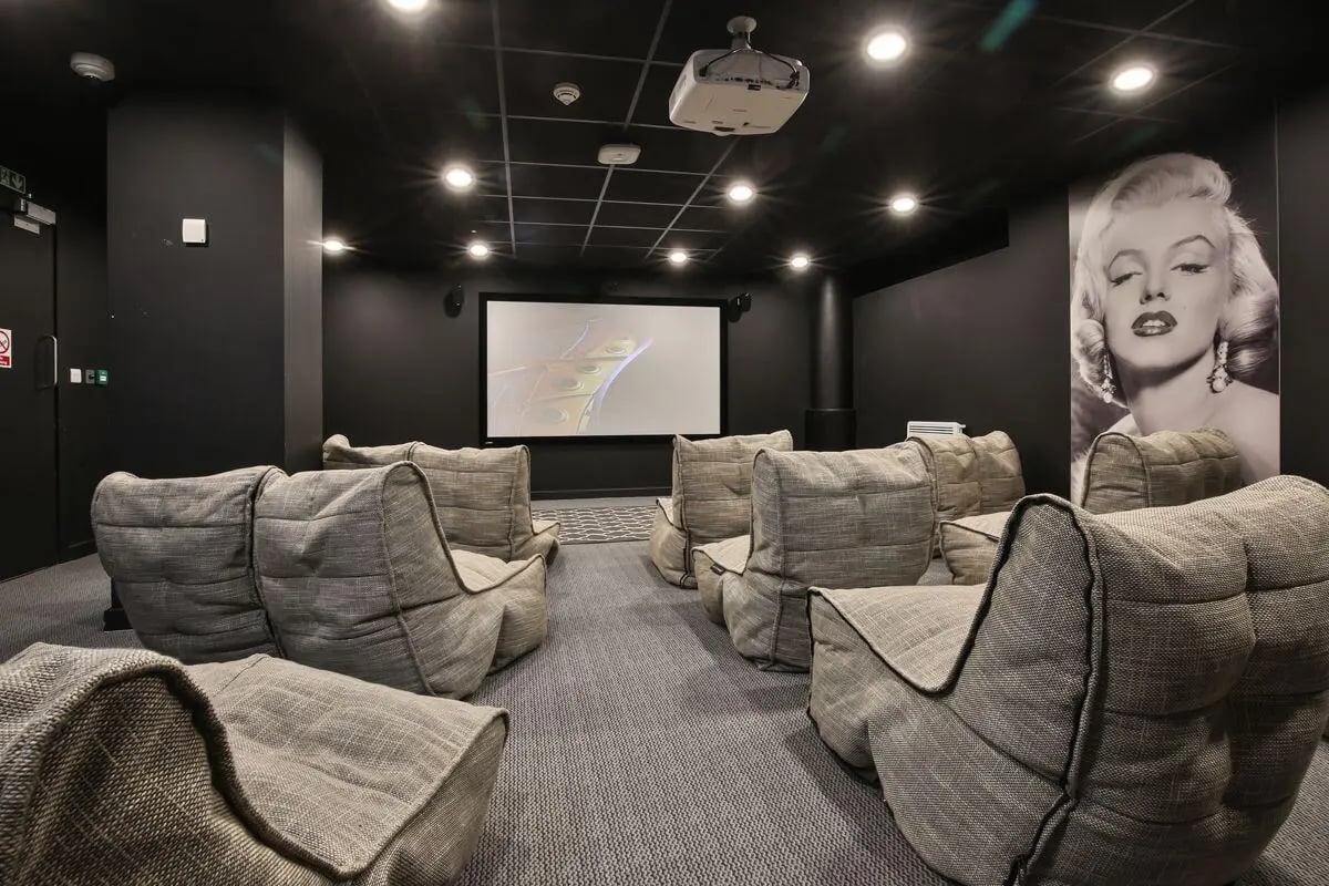 Beanbag chairs facing projector screen Marilyn Monroe poster cinema room at William & Matthew House in Bristol Student Accommodation