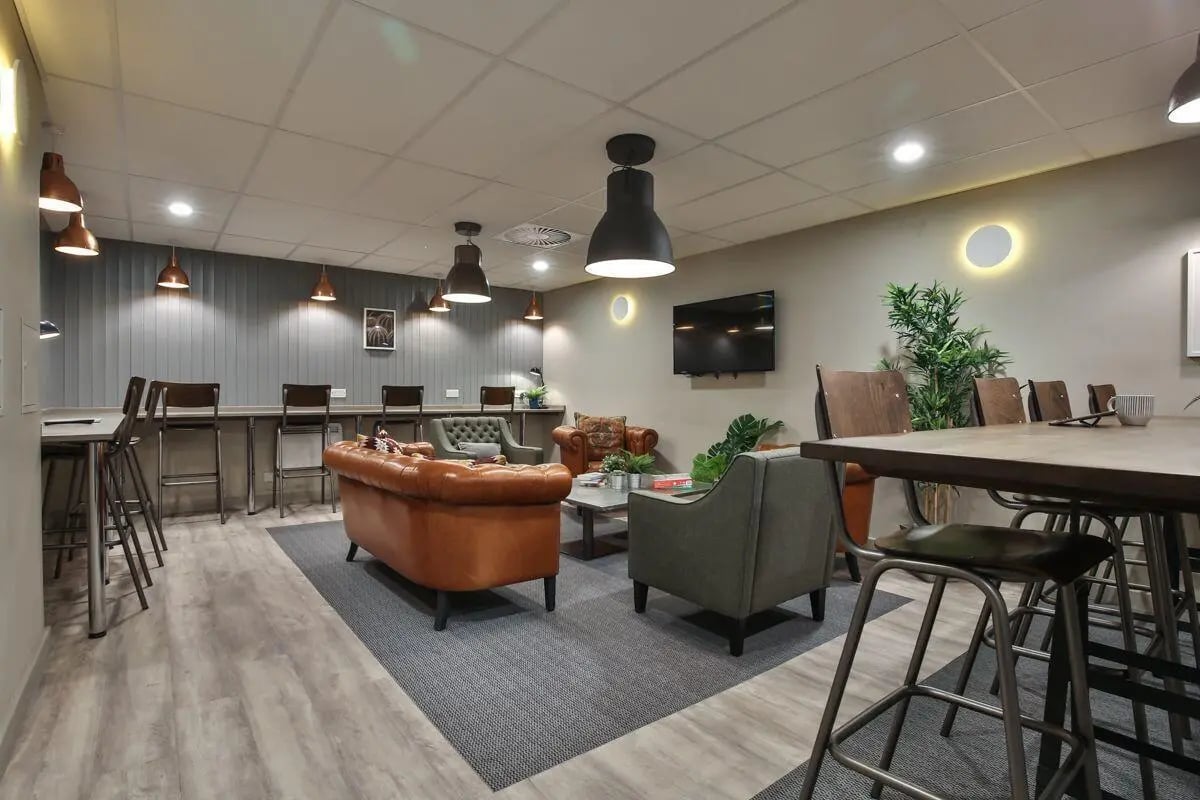 Sofas chairs tables television communal area at William & Matthew House in Bristol Student Accommodation