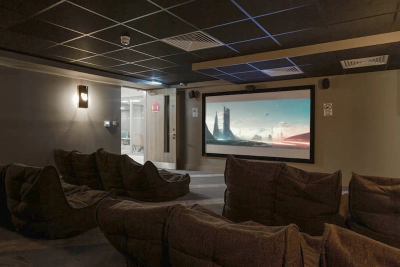 Bean bag chairs facing cinema screen playing movie playing area at West Gate in Exeter Student Accommodation