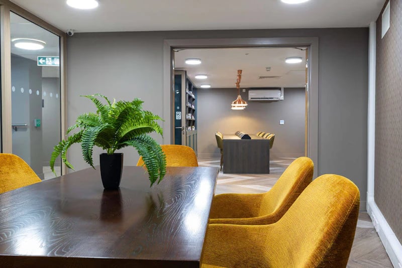 Dining table chairs plant open doorway communal area at West Gate in Exeter Student Accommodation