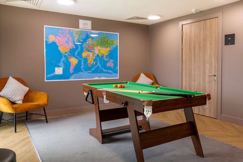 Pool table and chairs with world map playing area at West Gate in Exeter Student Accommodation