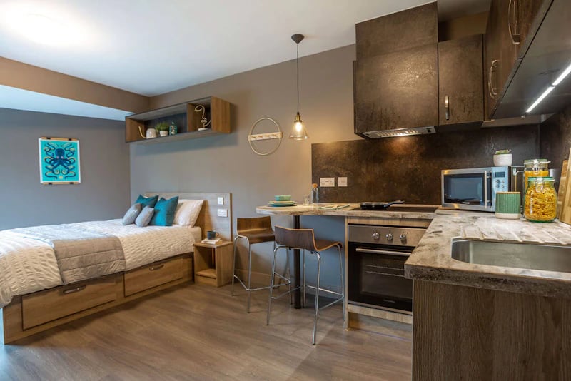 Bed kitchen with oven microwave and sink at West Gate in Exeter Student Accommodation