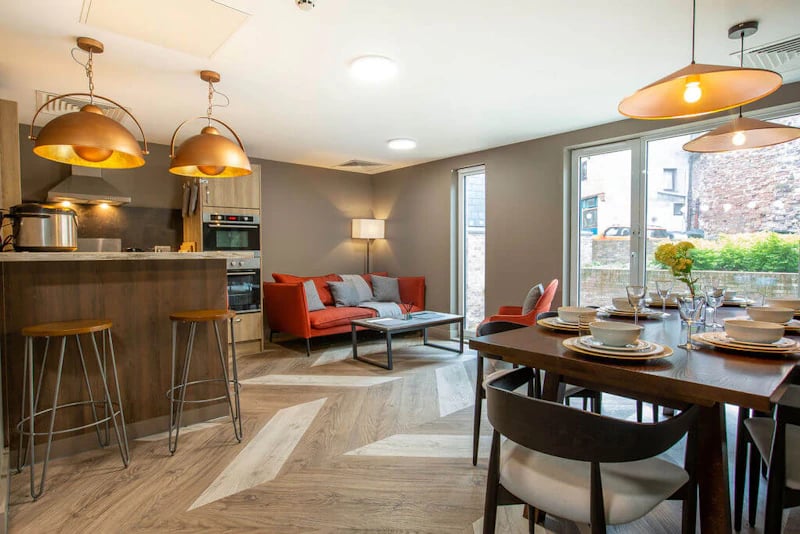 Kitchen dining area with sofa and dining table Living room at West Gate in Exeter Student Accommodation