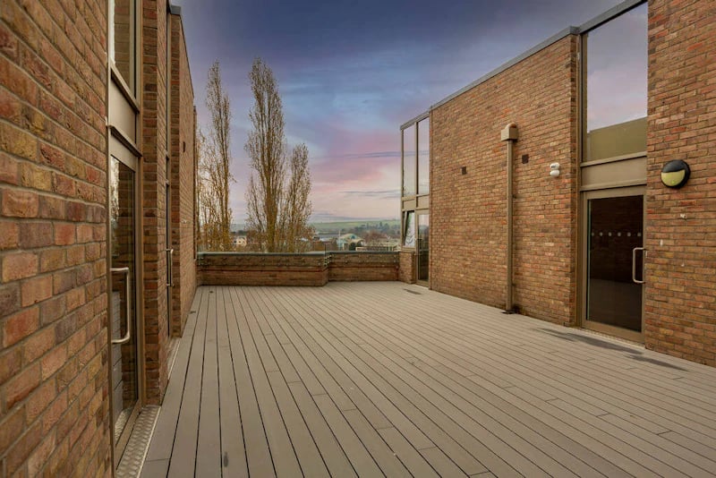 Brick building with deck and trees exterior at West Gate in Exeter Student Accommodation