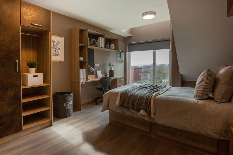 Wardrobe desk bed laundry bin bedroom at West Gate in Exeter Student Accommodation