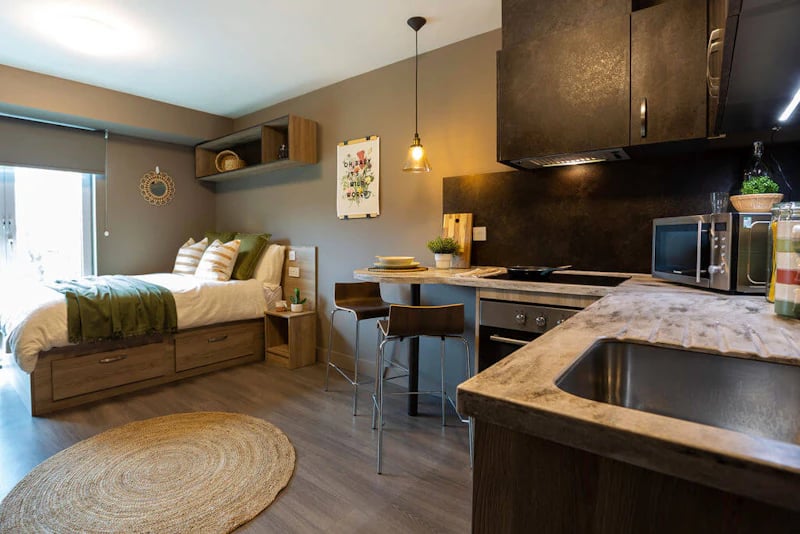 Bed kitchen island microwave and oven studio at West Gate in Exeter Student Accommodation