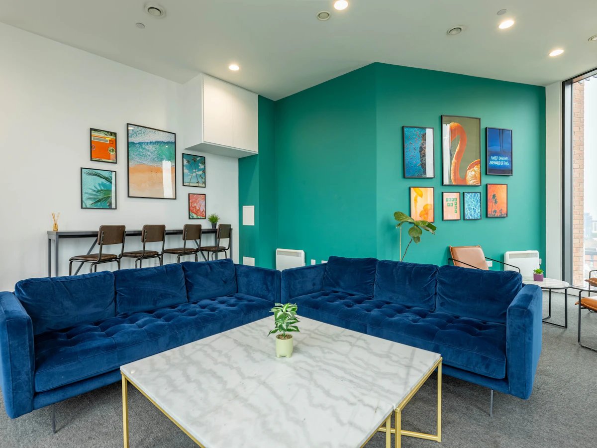 Blue sectional sofa marble table art living room at Straits Village in Nottingham Student Accommodation