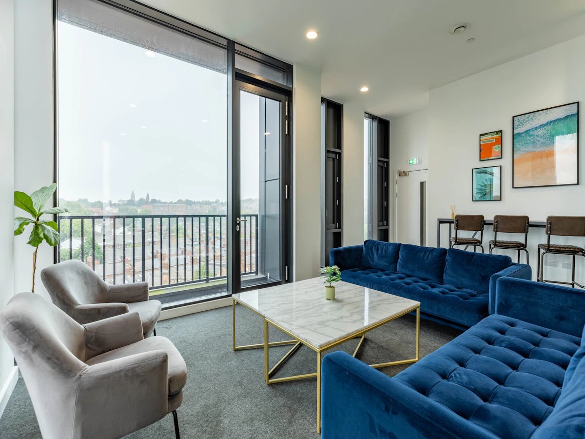 Blue couches marble table gray chairs living room at Straits Village in Nottingham Student Accommodation