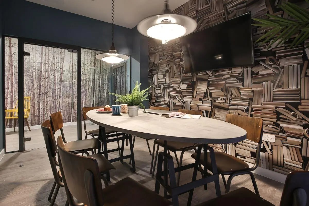 Oval table, chairs, TV, plant study area at King's Stables Road in Edinburgh Student Accommodation