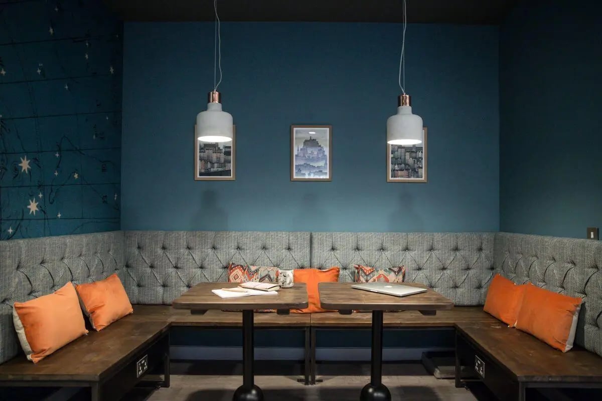 U-shaped bench seating with tables and lamps at King's Stables Road in Edinburgh Student Accommodation