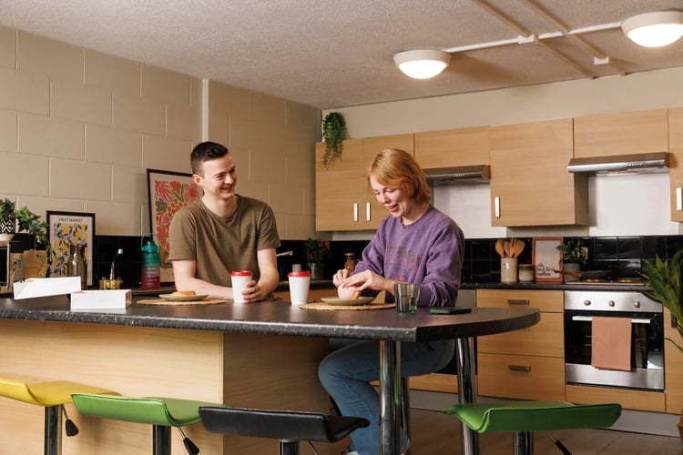 Students at kitchen counter with breakfast and coffee kitchen at Spring Gardens in Aberdeen Student Accommodation