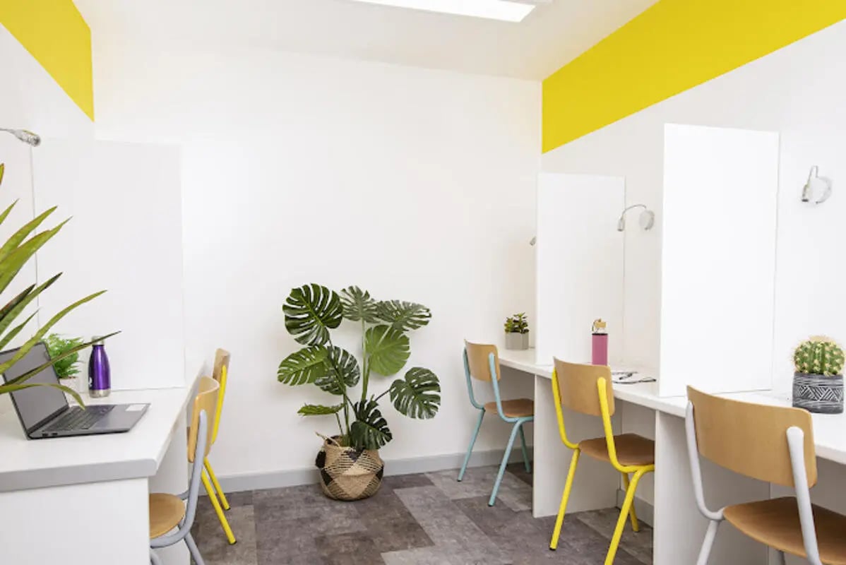 Desks chairs plants laptop water bottle study area at Lakeside in Birmingham Student Accommodation