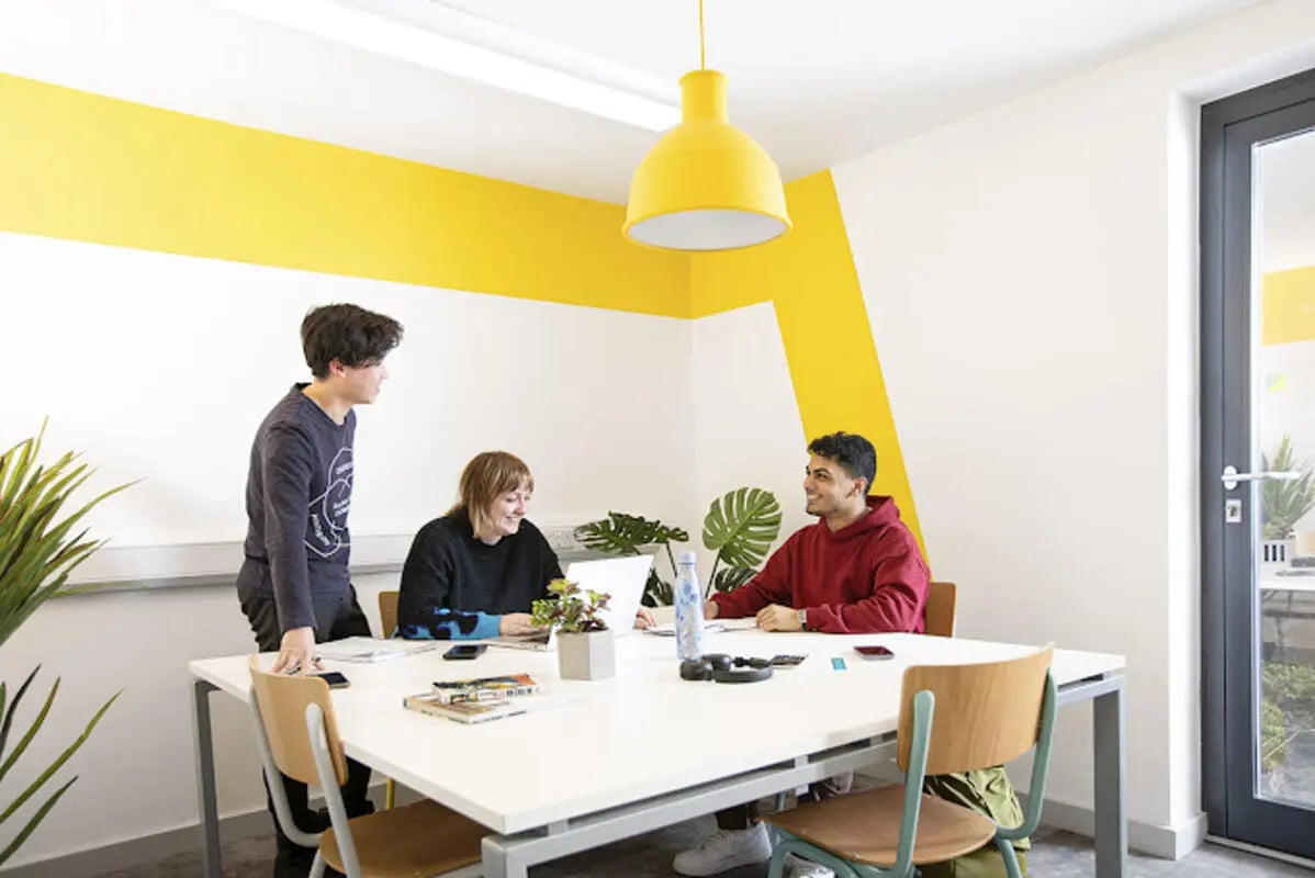 Students at table with laptop and plants study area at Lakeside in Birmingham Student Accommodation