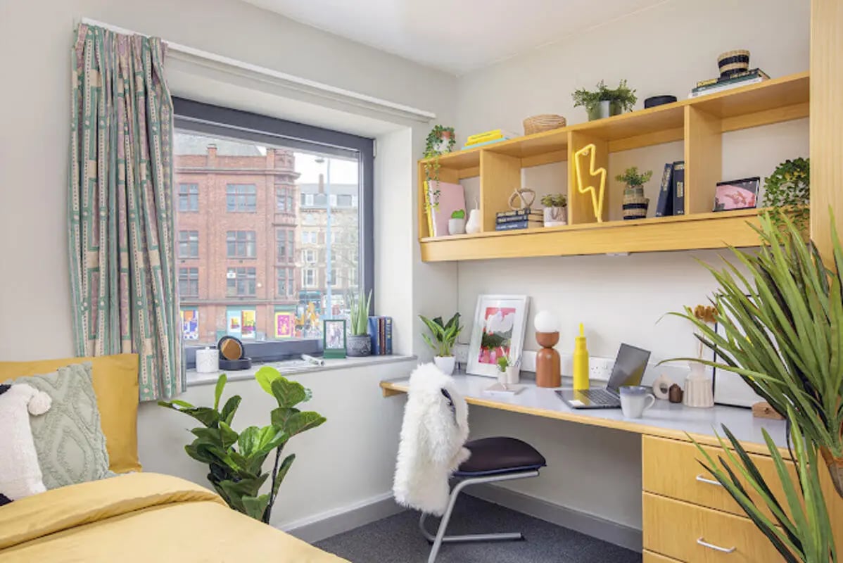 Desk with laptop plants shelves and bed bedroom at Lakeside in Birmingham Student Accommodation