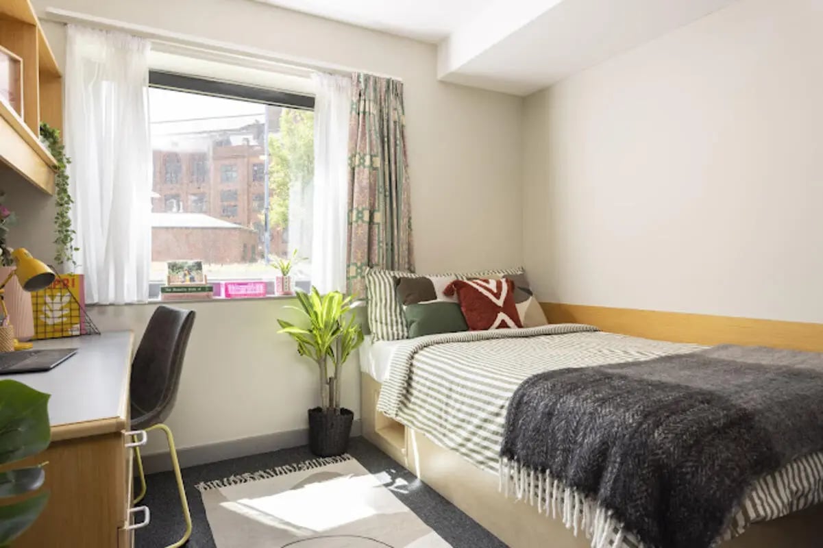 Desk bed plant and curtains bedroom at Lakeside in Birmingham Student Accommodation