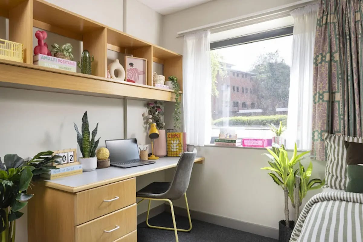 Desk with laptop plants and shelves bedroom at Lakeside in Birmingham Student Accommodation
