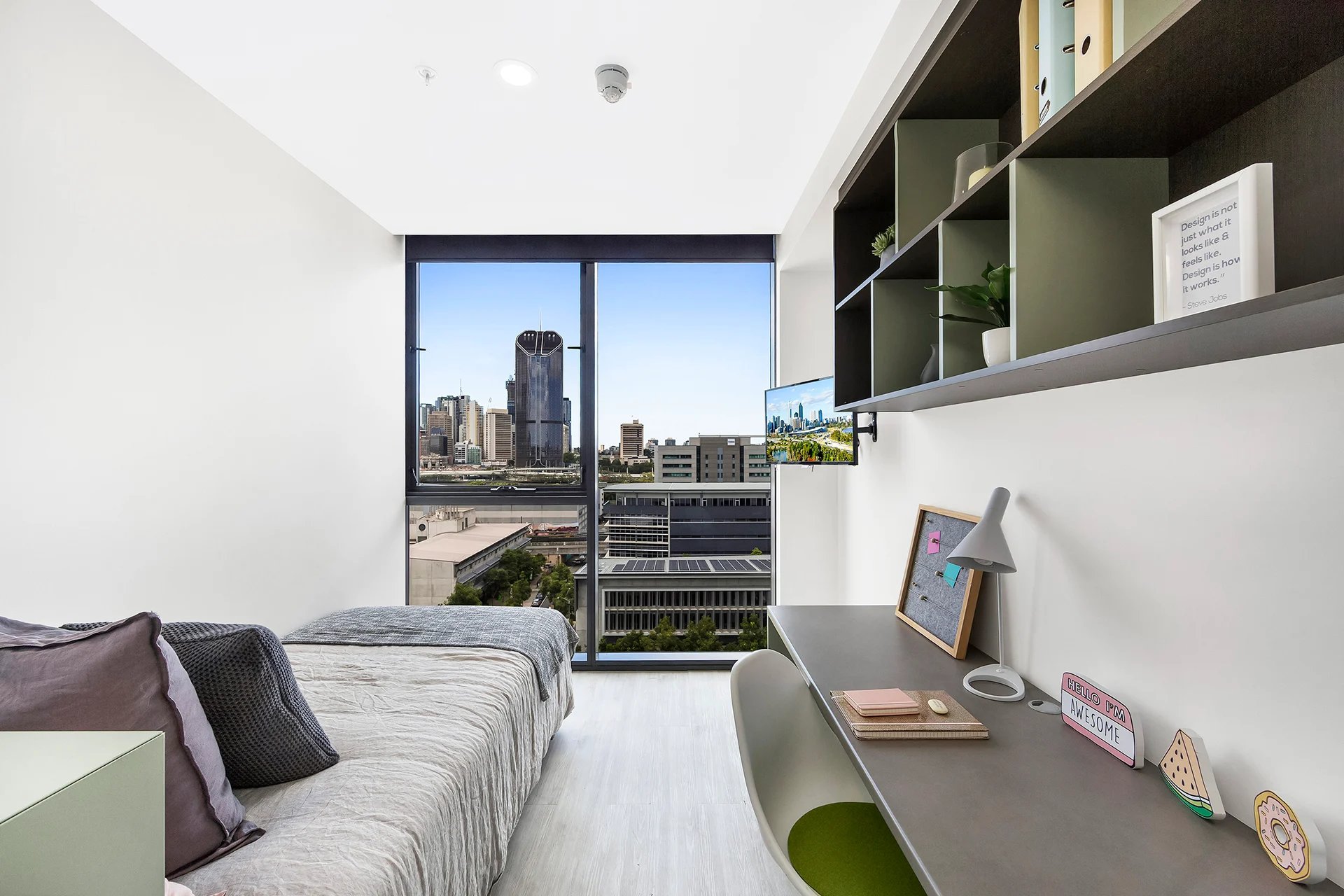 Bed desk and city view student accommodation bedroom at Scape Merivale in Brisbane Student Accommodation