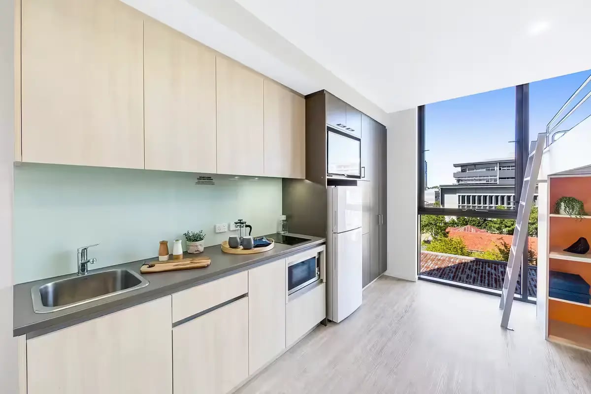 Modern kitchenette with fridge microwave sink and cabinets kitchen at Scape Merivale in Brisbane Student Accommodation