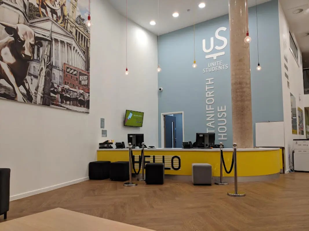 Reception desk with computers and stools lobby at Staniforth House in Birmingham Student Accommodation