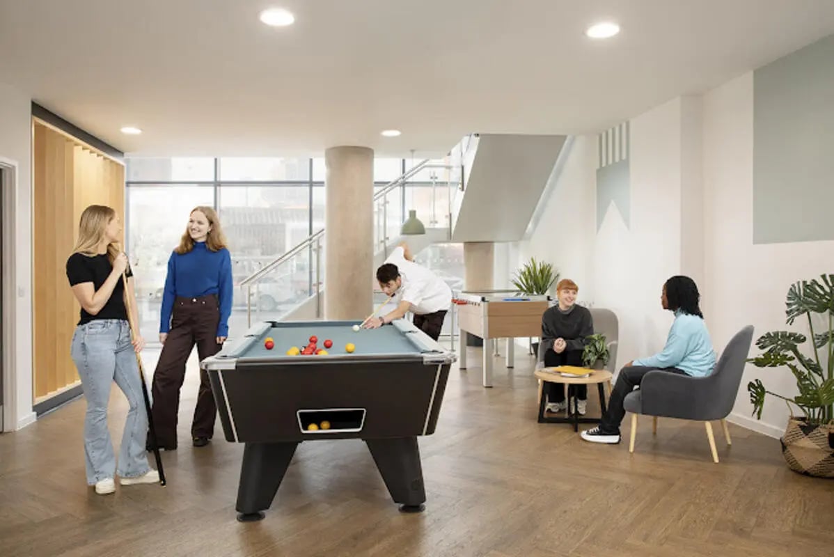 People playing pool and foosball common area at Staniforth House in Birmingham Student Accommodation