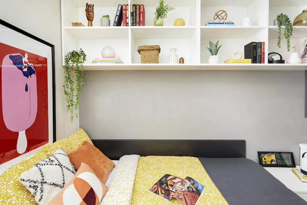 Poster bed shelves pillows and artwork bedroom at Staniforth House in Birmingham Student Accommodation